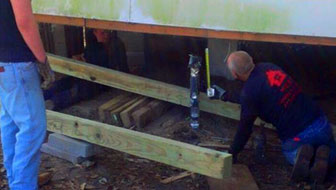 Staff Attending to the Foundation of the House